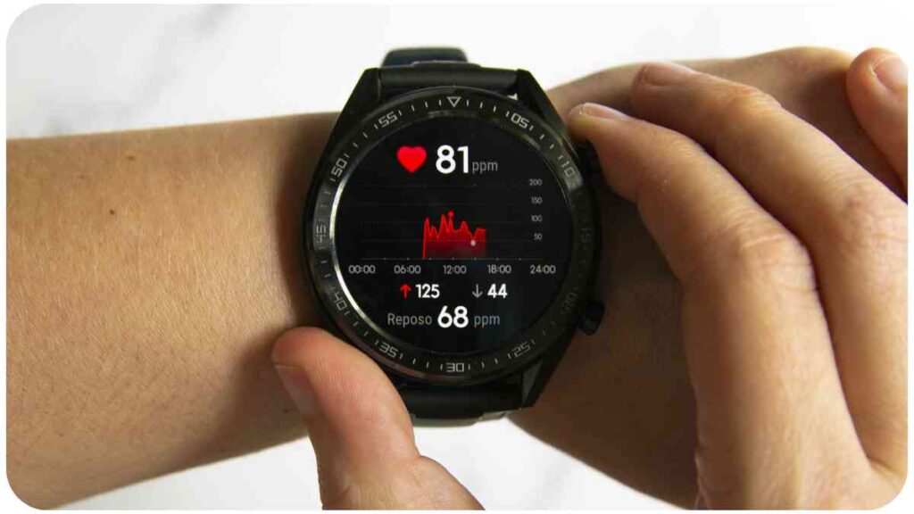 a person holding a smart watch with a heart rate monitor on it