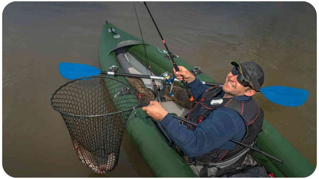 a person in a kayak holding a fishing net