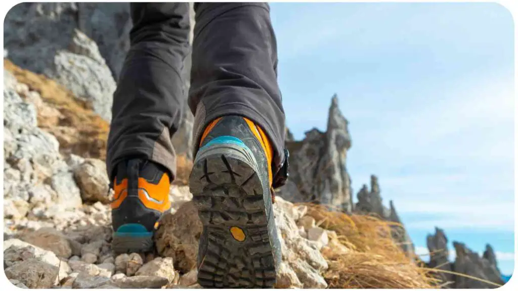 a person wearing hiking shoes walking up a mountain