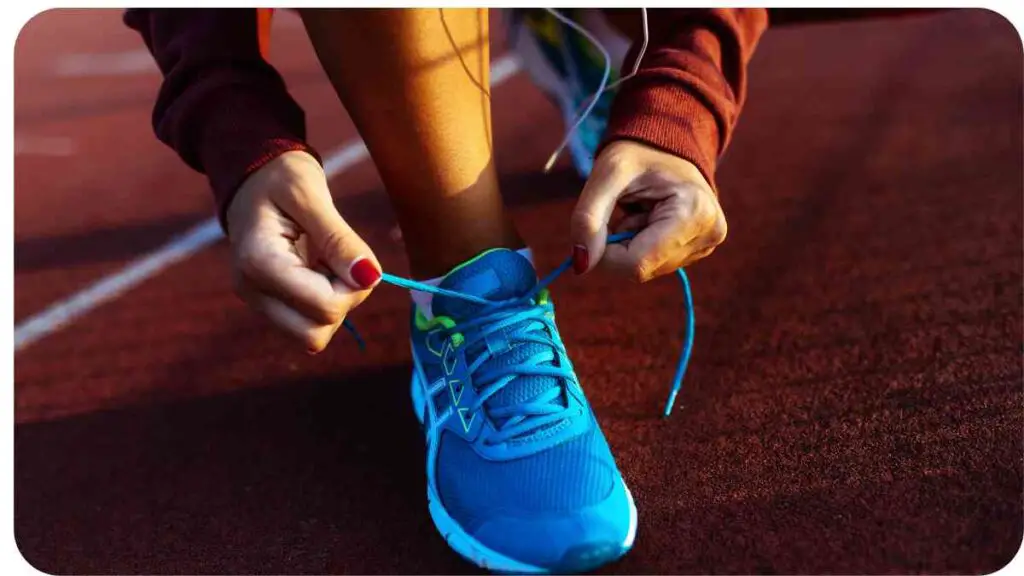 a person tying their shoes on a running track