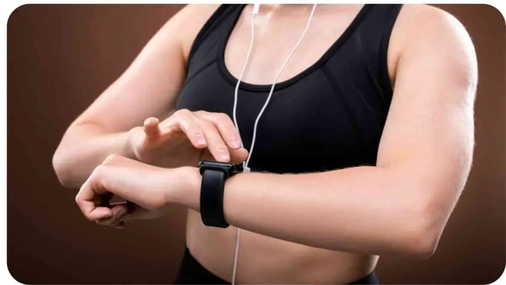 a person in a sports bra is checking the time on their smart watch